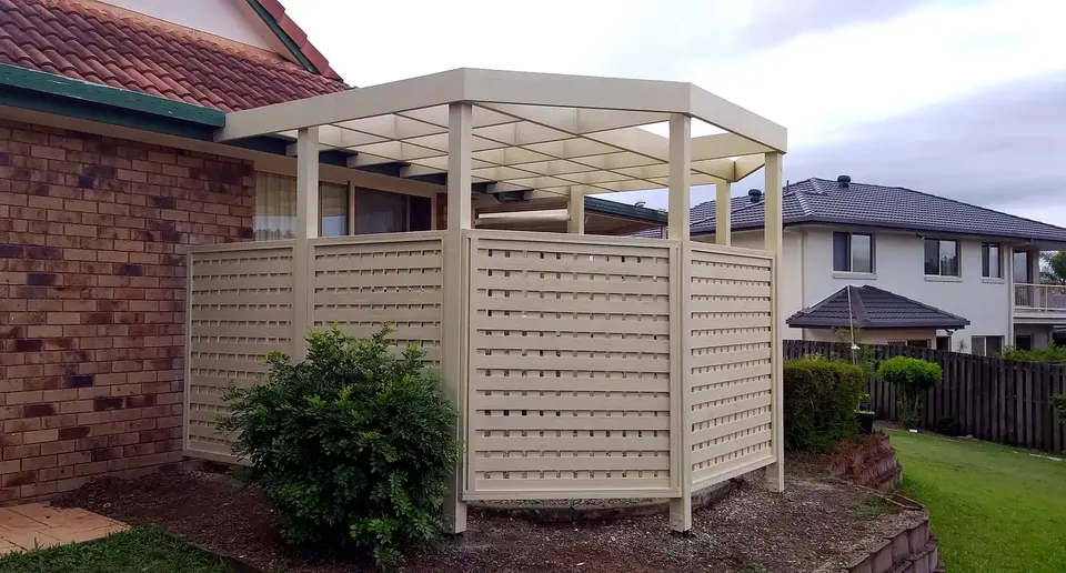cream pergola and privacy screen built in a backyard